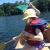 child canoeing and holding a canoe paddle